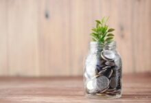 a glass jar filled with coins and a plant