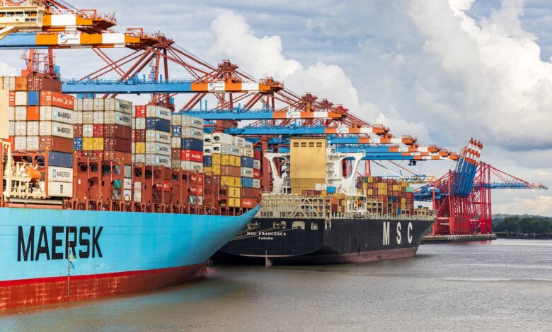 blue and red cargo ship on dock during daytime