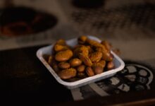 a bowl of peanuts sitting on top of a table