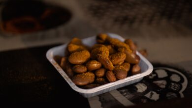 a bowl of peanuts sitting on top of a table