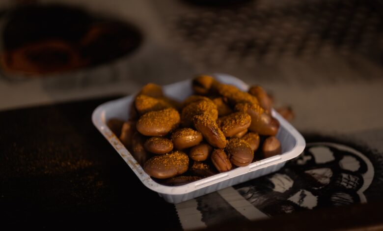 a bowl of peanuts sitting on top of a table