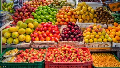 red and green apples on red plastic crate