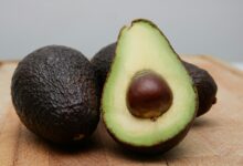 sliced avocado fruit on brown wooden table