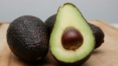 sliced avocado fruit on brown wooden table