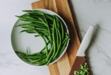 green and white vegetable on brown wooden chopping board