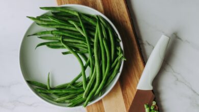 green and white vegetable on brown wooden chopping board