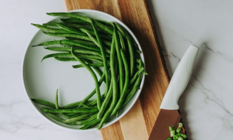 green and white vegetable on brown wooden chopping board