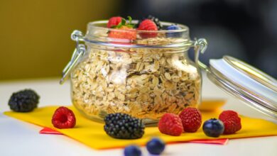 clear glass jar with black berries