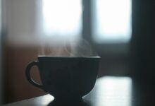 black ceramic teacup on table